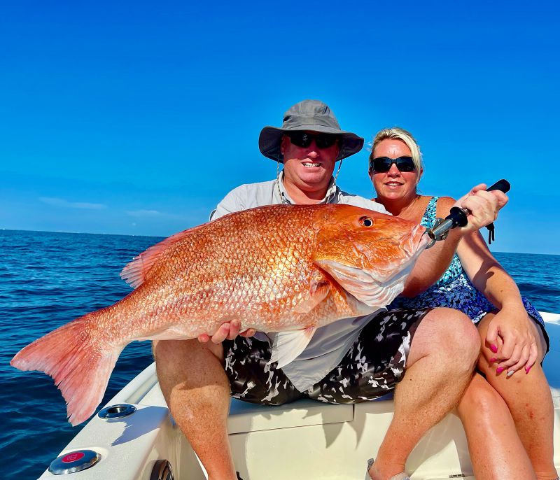 Man and Woman Holding a Red Snapper